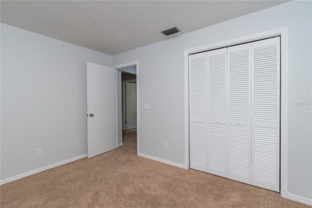 1406 SE Wacahoota Rd, Micanopy, FL 32667 - unfurnished bedroom featuring light carpet, a closet, and baseboards