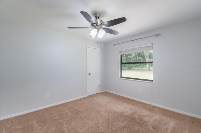 1406 SE Wacahoota Rd, Micanopy, FL 32667 - spare room with light carpet, a ceiling fan, and baseboards