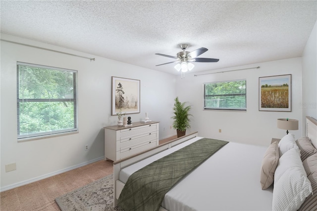 1406 SE Wacahoota Rd, Micanopy, FL 32667 - carpeted bedroom with a textured ceiling, baseboards, and a ceiling fan