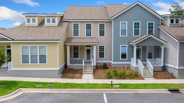 view of front of home with a shingled roof and a porch