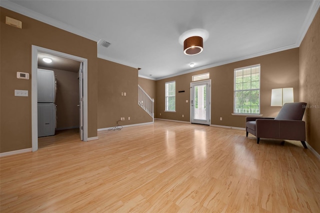 interior space featuring stairway, crown molding, plenty of natural light, and light wood-style floors