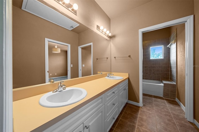 bathroom featuring a sink, double vanity, baseboards, and tile patterned floors