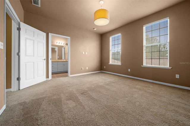 empty room featuring visible vents, baseboards, and carpet floors