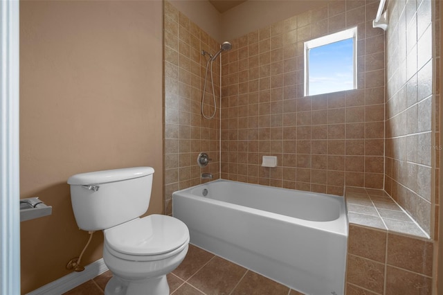 bathroom featuring toilet, tile patterned flooring, and shower / bathtub combination