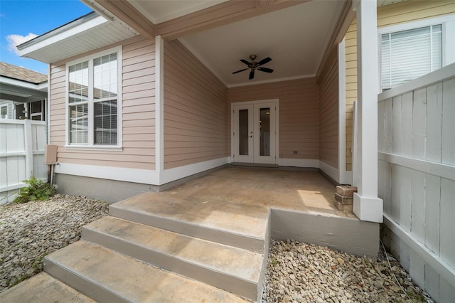 doorway to property with fence, french doors, and a ceiling fan