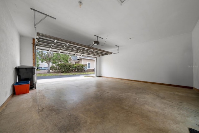 garage featuring baseboards and a garage door opener