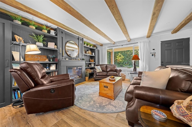 13232 NE 39th Ter, Anthony, FL 32617 - living room featuring a glass covered fireplace, beam ceiling, and wood finished floors