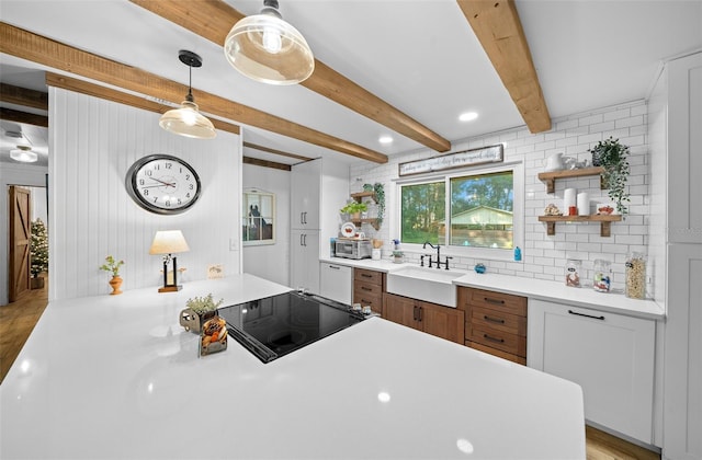 13232 NE 39th Ter, Anthony, FL 32617 - kitchen featuring open shelves, backsplash, black electric stovetop, and a sink