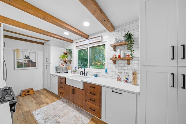 13232 NE 39th Ter, Anthony, FL 32617 - kitchen featuring a sink, open shelves, light wood-style flooring, backsplash, and beamed ceiling