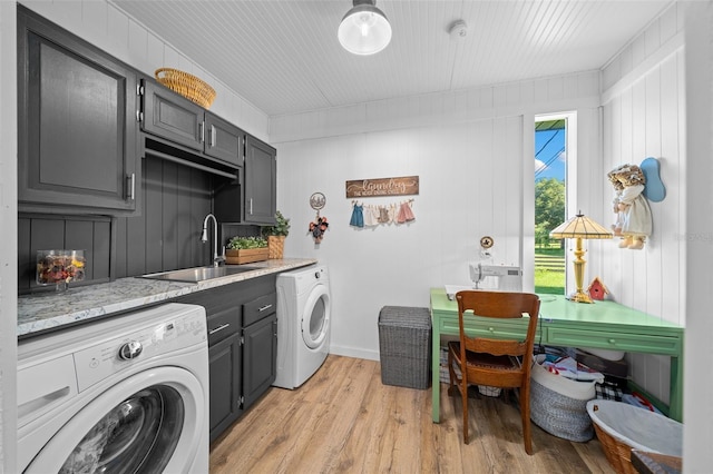 13232 NE 39th Ter, Anthony, FL 32617 - laundry room featuring a sink, cabinet space, light wood finished floors, separate washer and dryer, and baseboards
