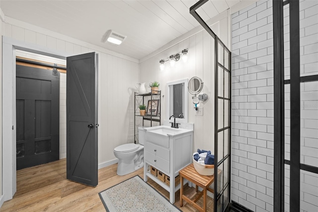 13232 NE 39th Ter, Anthony, FL 32617 - full bath featuring toilet, wood finished floors, vanity, and a tile shower
