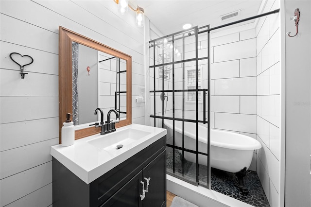 13232 NE 39th Ter, Anthony, FL 32617 - full bath with tile walls, visible vents, vanity, and a freestanding bath