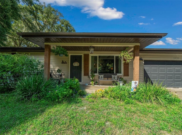 13232 NE 39th Ter, Anthony, FL 32617 - view of front of house featuring a porch, an attached garage, and driveway