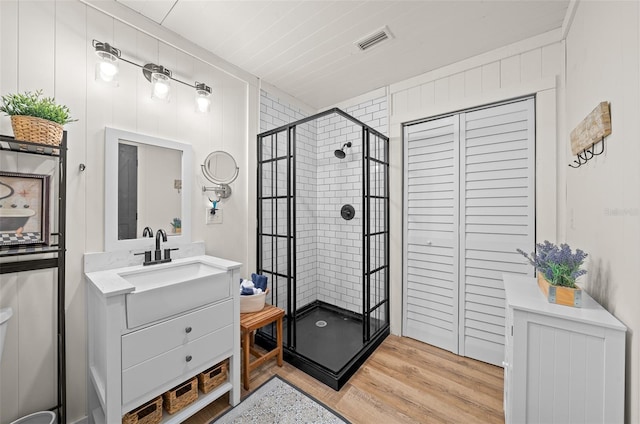 13232 NE 39th Ter, Anthony, FL 32617 - bathroom with a shower stall, vanity, visible vents, and wood finished floors