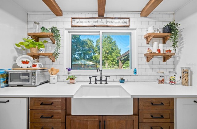 13232 NE 39th Ter, Anthony, FL 32617 - kitchen with a sink, open shelves, light countertops, and beam ceiling