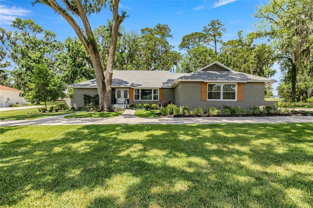 5326 NW 76th Ct, Ocala, FL 34482 - ranch-style house with a front yard, stucco siding, and a shingled roof