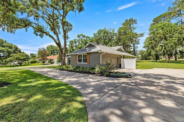 5326 NW 76th Ct, Ocala, FL 34482 - view of front of property featuring an attached garage, driveway, and a front lawn