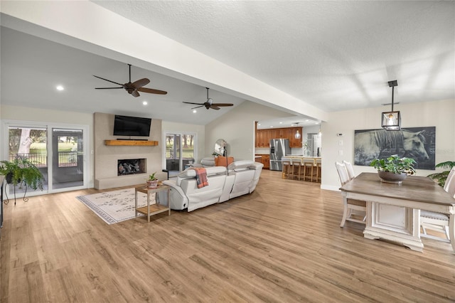 5326 NW 76th Ct, Ocala, FL 34482 - living room with lofted ceiling, light wood-style floors, a fireplace, a ceiling fan, and recessed lighting