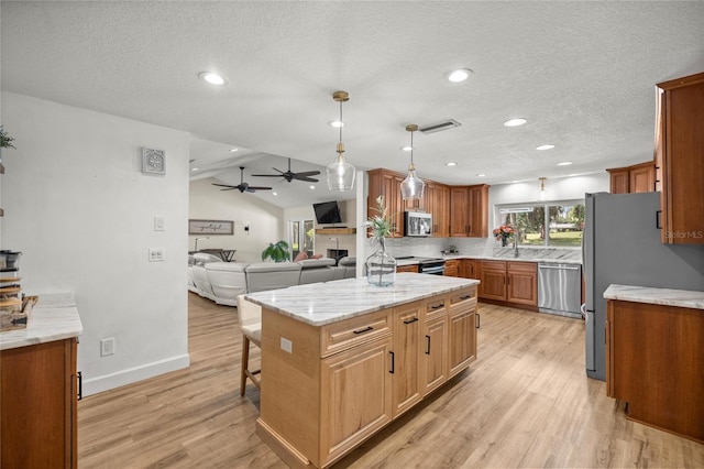 5326 NW 76th Ct, Ocala, FL 34482 - kitchen featuring stainless steel appliances, a ceiling fan, light wood-style floors, lofted ceiling, and open floor plan