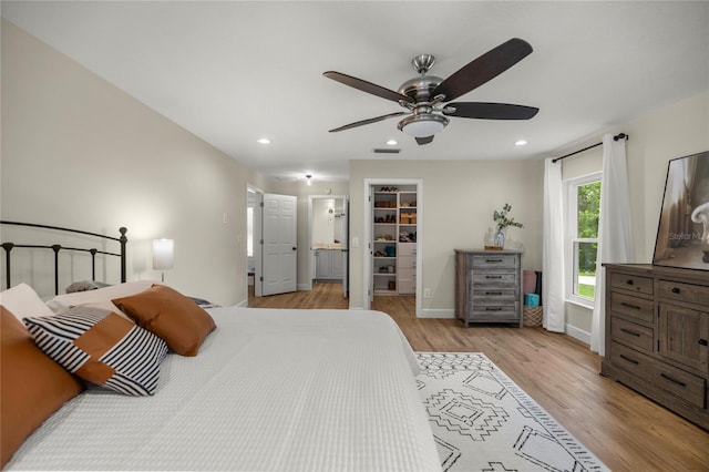 5326 NW 76th Ct, Ocala, FL 34482 - bedroom featuring light wood finished floors, a walk in closet, recessed lighting, a ceiling fan, and baseboards