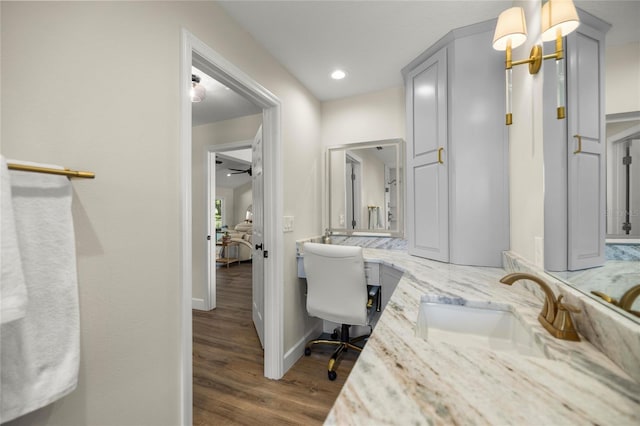 5326 NW 76th Ct, Ocala, FL 34482 - bathroom featuring wood finished floors, double vanity, recessed lighting, and baseboards