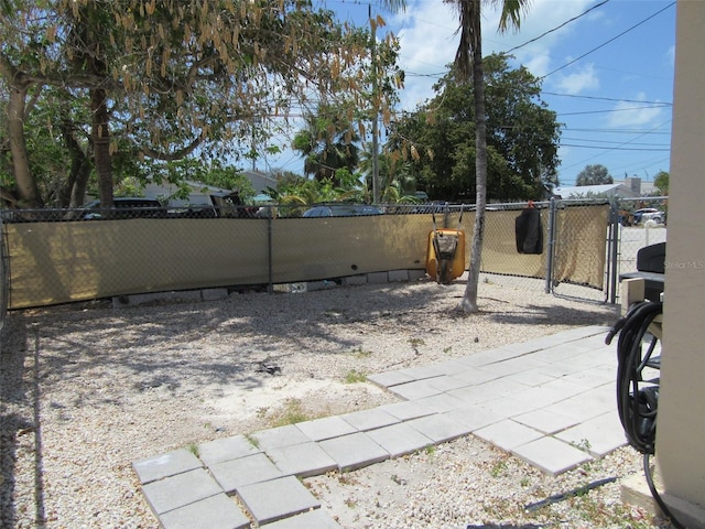 view of yard with fence and a gate