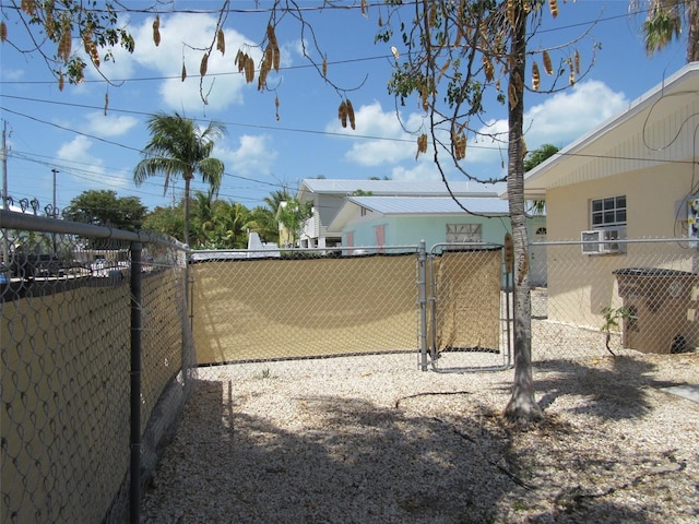 view of yard with fence and a gate