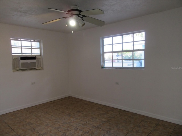 unfurnished room featuring a ceiling fan, baseboards, and cooling unit