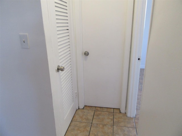 hallway featuring light tile patterned floors