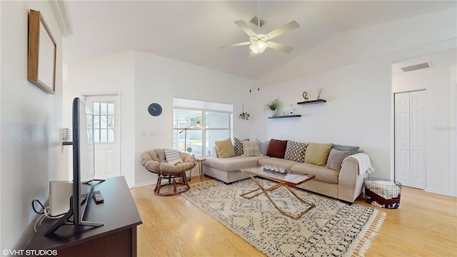 living area with light wood-style floors, visible vents, lofted ceiling, and ceiling fan