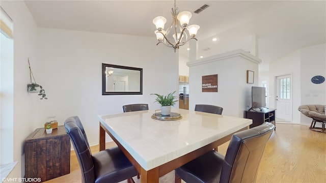 dining area featuring light wood-type flooring, visible vents, recessed lighting, vaulted ceiling, and a chandelier