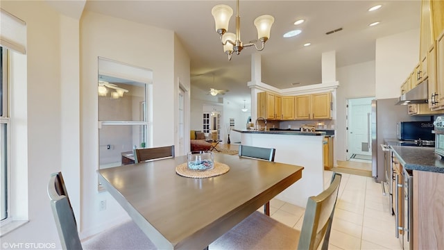 dining area featuring light tile patterned floors, visible vents, and ceiling fan with notable chandelier
