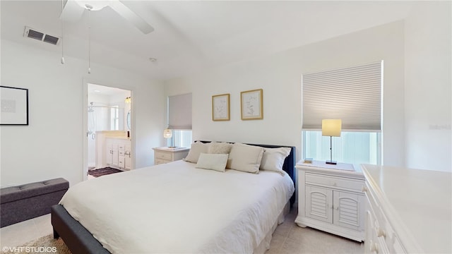 bedroom featuring light tile patterned floors, visible vents, and multiple windows
