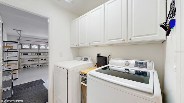 laundry room with cabinet space and washer and dryer