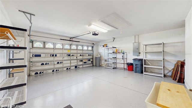 garage with electric panel and a garage door opener