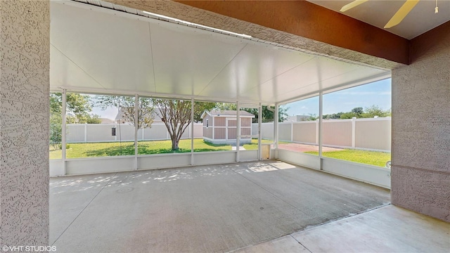 unfurnished sunroom with a ceiling fan