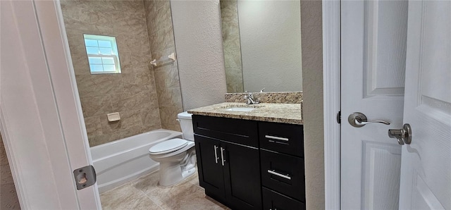 full bath with toilet,  shower combination, tile patterned flooring, a textured wall, and vanity