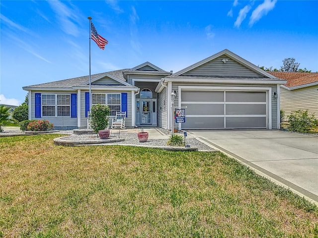 single story home with driveway, an attached garage, and a front yard