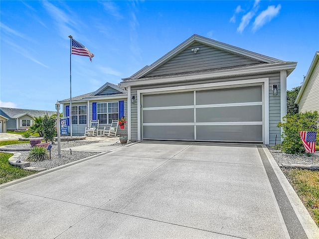 ranch-style home featuring concrete driveway and an attached garage