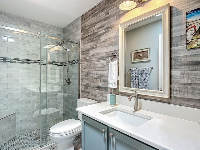 bathroom with vanity, toilet, and a stall shower