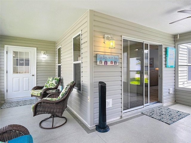 property entrance featuring a ceiling fan and a porch