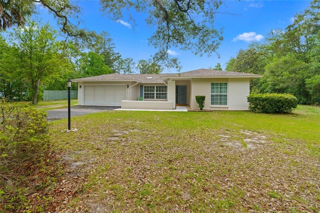 8130 SW 209th Court Rd, Dunnellon, FL 34431 - ranch-style home featuring a garage, stucco siding, and asphalt driveway