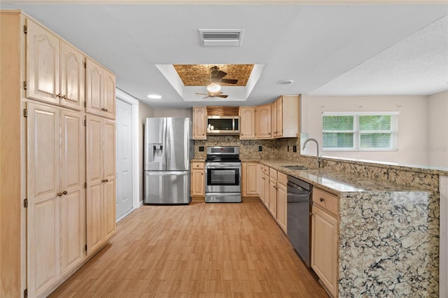 8130 SW 209th Court Rd, Dunnellon, FL 34431 - kitchen featuring appliances with stainless steel finishes, a sink, light brown cabinets, a peninsula, and recessed lighting
