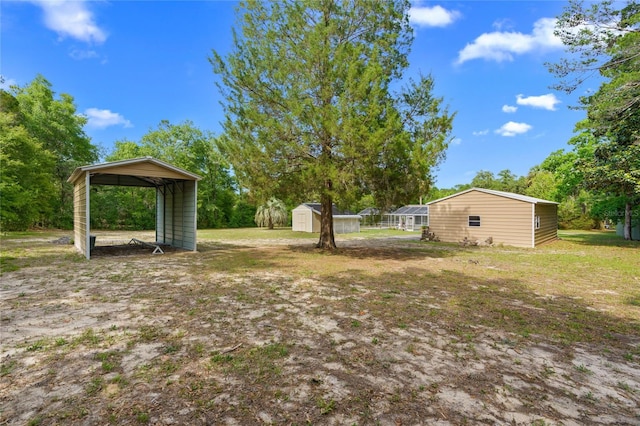 8130 SW 209th Court Rd, Dunnellon, FL 34431 - view of grassy yard with a shed, a detached carport, and an outdoor structure
