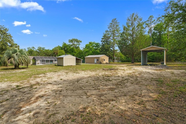 8130 SW 209th Court Rd, Dunnellon, FL 34431 - view of yard featuring a detached carport, an outbuilding, and view of scattered trees