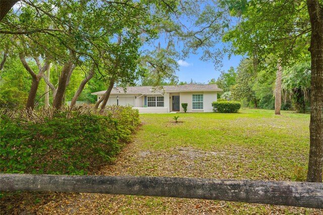 8130 SW 209th Court Rd, Dunnellon, FL 34431 - ranch-style house featuring stucco siding and a front lawn