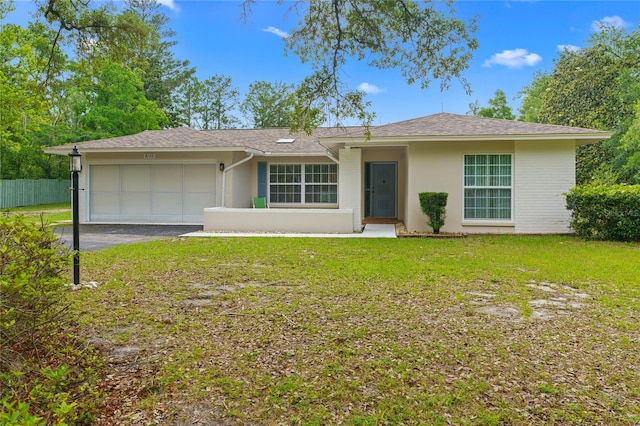 8130 SW 209th Court Rd, Dunnellon, FL 34431 - ranch-style home with a garage, stucco siding, driveway, and roof with shingles
