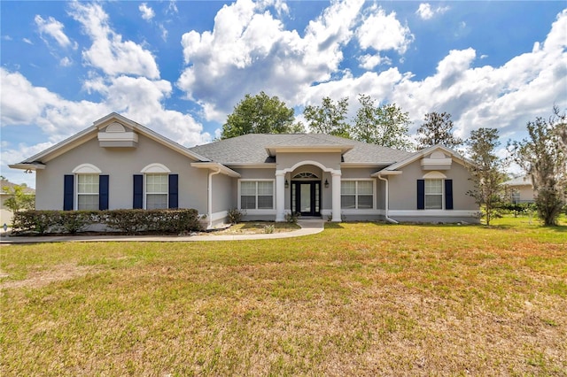 single story home with a front lawn and stucco siding