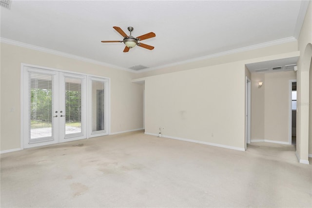 empty room with crown molding, baseboards, and french doors