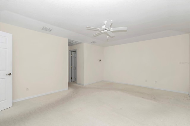 empty room with visible vents, baseboards, ceiling fan, and light carpet